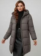 Redish-brown Holly Lumina longline hooded puffer coat with minimalist design, featuring a cozy, insulated look and a stylish silhouette.