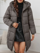 Holly cozy longline hooded puffer coat by Lumina Wear in reddish-brown, featuring a minimalist design and insulated warmth.