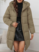 Red-brown Holly longline hooded puffer coat by Lumina Wear, featuring a minimalist design and cozy, padded insulation.
