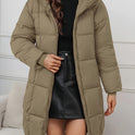 Redish-brown Lumina Wear Holly longline hooded puffer coat with minimalist design, showcasing its cozy, insulated, and stylish silhouette.