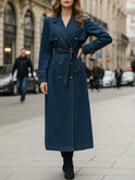 Indigo double-breasted trench coat by Lumina Wear, featuring classic design and tailored fit, displayed on a mannequin.