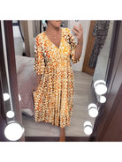 Red Elviira boho printed dress by Lumina Vancouver, featuring a flowy design and vibrant bohemian pattern.