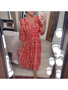 Red Elviira boho printed dress by Lumina Vancouver featuring a relaxed fit and vibrant floral pattern.