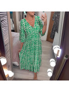 Red Elviira boho printed dress by Lumina Vancouver featuring floral patterns and flowing fabric, perfect for casual or summer wear.