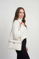 Lumina Wear Isabella black crossbody bag with adjustable strap, stylish handbag with sleek design and compact size.