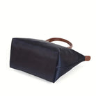 Isabella Lumina black faux leather handbag with spacious design, stylish hand-held bag for women, on a plain background.