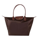 Isabella Lumina black faux leather handbag with spacious interior and stylish design, featuring sturdy handles and modern details.