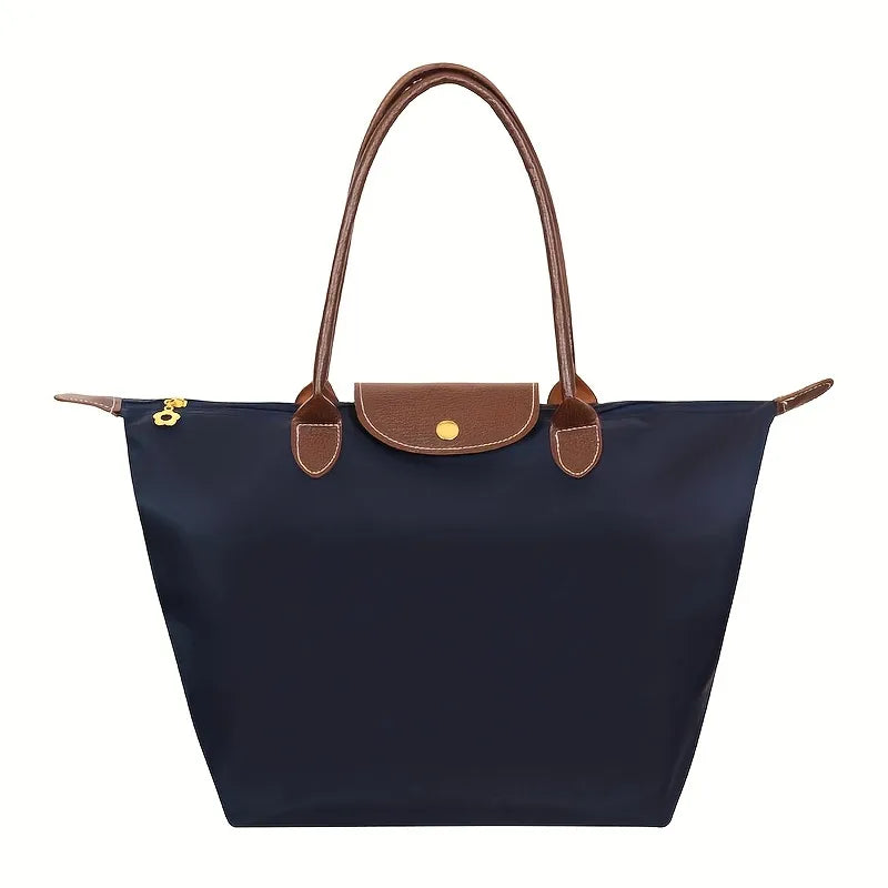 Black faux leather handbag named Isabella by Lumina Wear, featuring a spacious design and chic style.