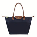 Black faux leather Isabella handbag by Lumina Wear featuring a spacious design and chic style.