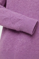 Dark purple Lumina Wear Isabella cozy sweater with a flattering fit, shown on a model. Soft knit fabric with a stylish, comfortable design.