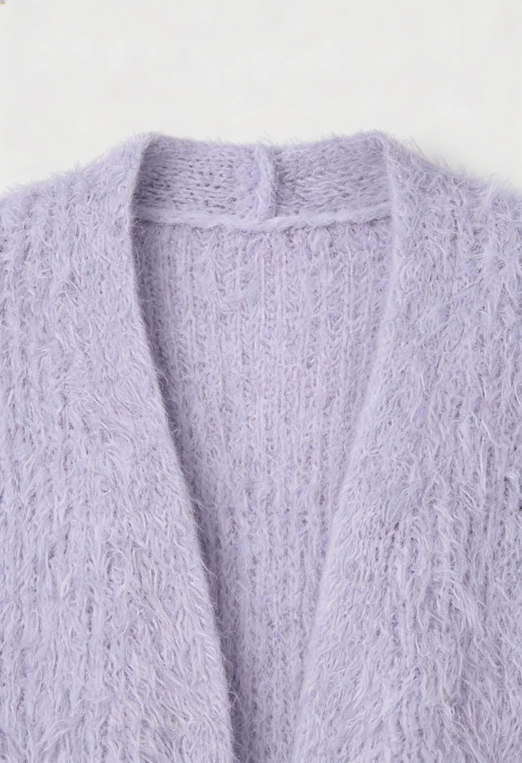 Cozy purple knit cardigan with ribbed details from Lumina Wear, featuring a relaxed fit and textured fabric for comfort and style.