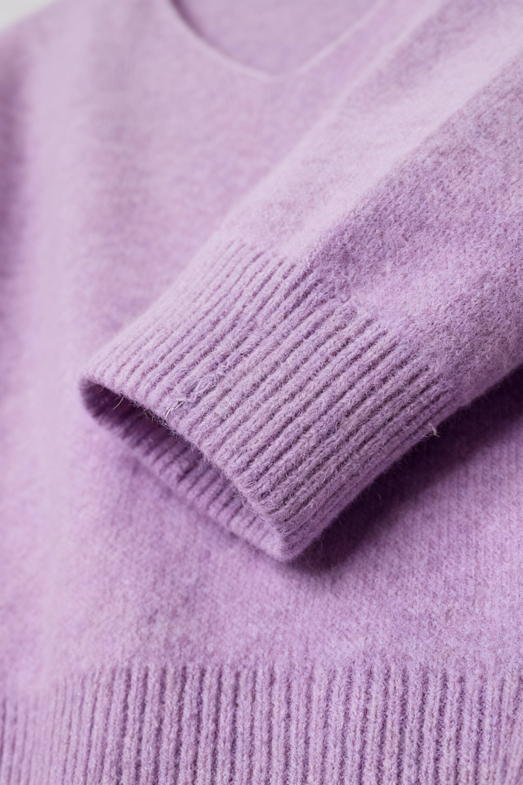 Lumina Wear Isabella cozy purple knit sweater with V-neckline, featuring soft texture and long sleeves, perfect for casual wear.