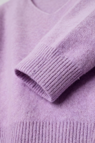 Lumina Wear Isabella cozy purple knit sweater with V-neckline, featuring soft texture and long sleeves, perfect for casual wear.