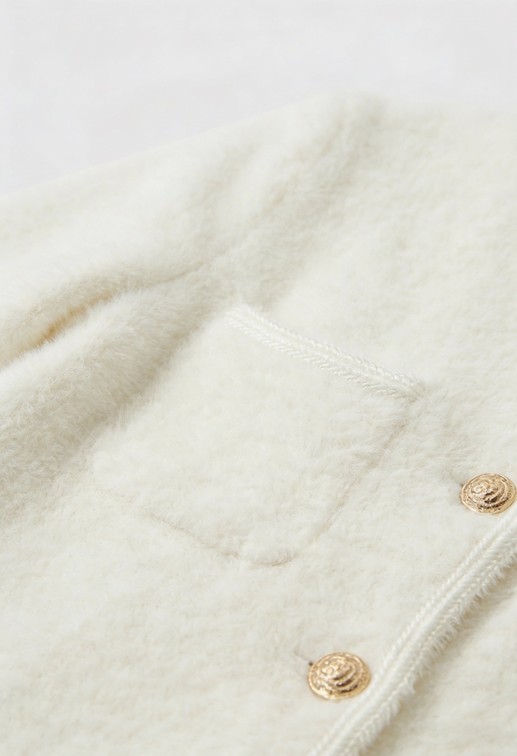 Lumina Wear Isabella cozy white cardigan sweater with ribbed hem, styled on a woman, soft knit fabric, casual and comfortable.
