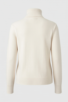 Lumina Wear Isabella apricot turtleneck sweater with slim fit, showcasing the cozy, elegant knit design and fitted silhouette.