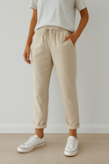 Elegant beige trousers by Lumina Wear featuring breathable fabric, styled with a relaxed fit and tailored design.