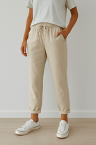 Elegant beige trousers by Lumina Wear featuring breathable fabric, modeled on a person wearing stylish, comfortable Trousers.