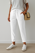 Elegant beige Lumina Wear Isabella trousers made of breathable fabric, showcasing a stylish and comfortable pants design.