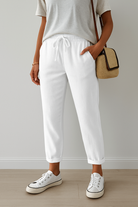 Elegant beige Lumina Wear Isabella trousers made of breathable fabric, shown with a tailored fit and classic design.