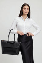 Elegant black crocodile leather handbag by Lumina Wear featuring an adjustable strap and sophisticated design.