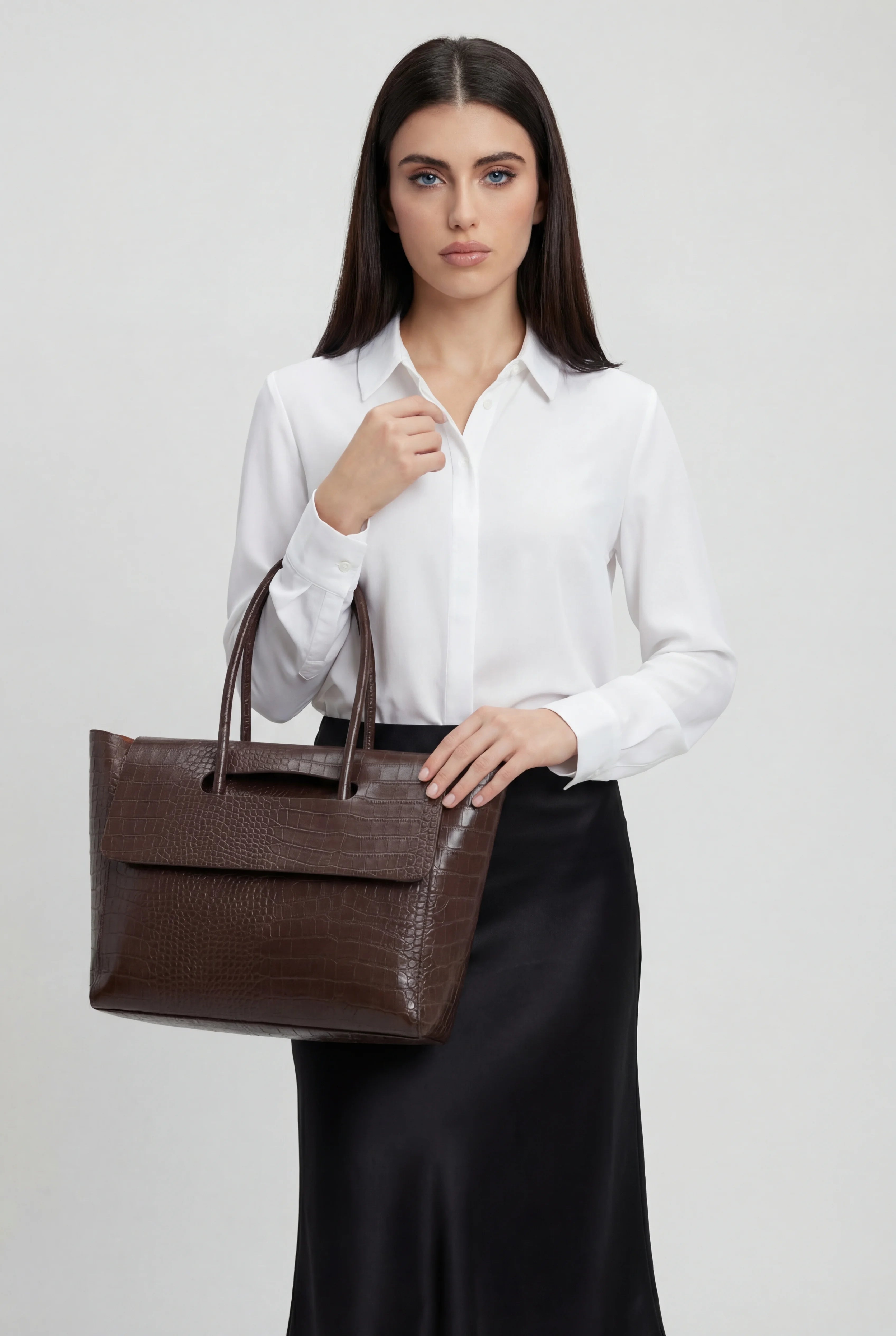 Elegant black crocodile leather handbag with adjustable strap from Lumina Wear, showcasing a stylish and sophisticated design.