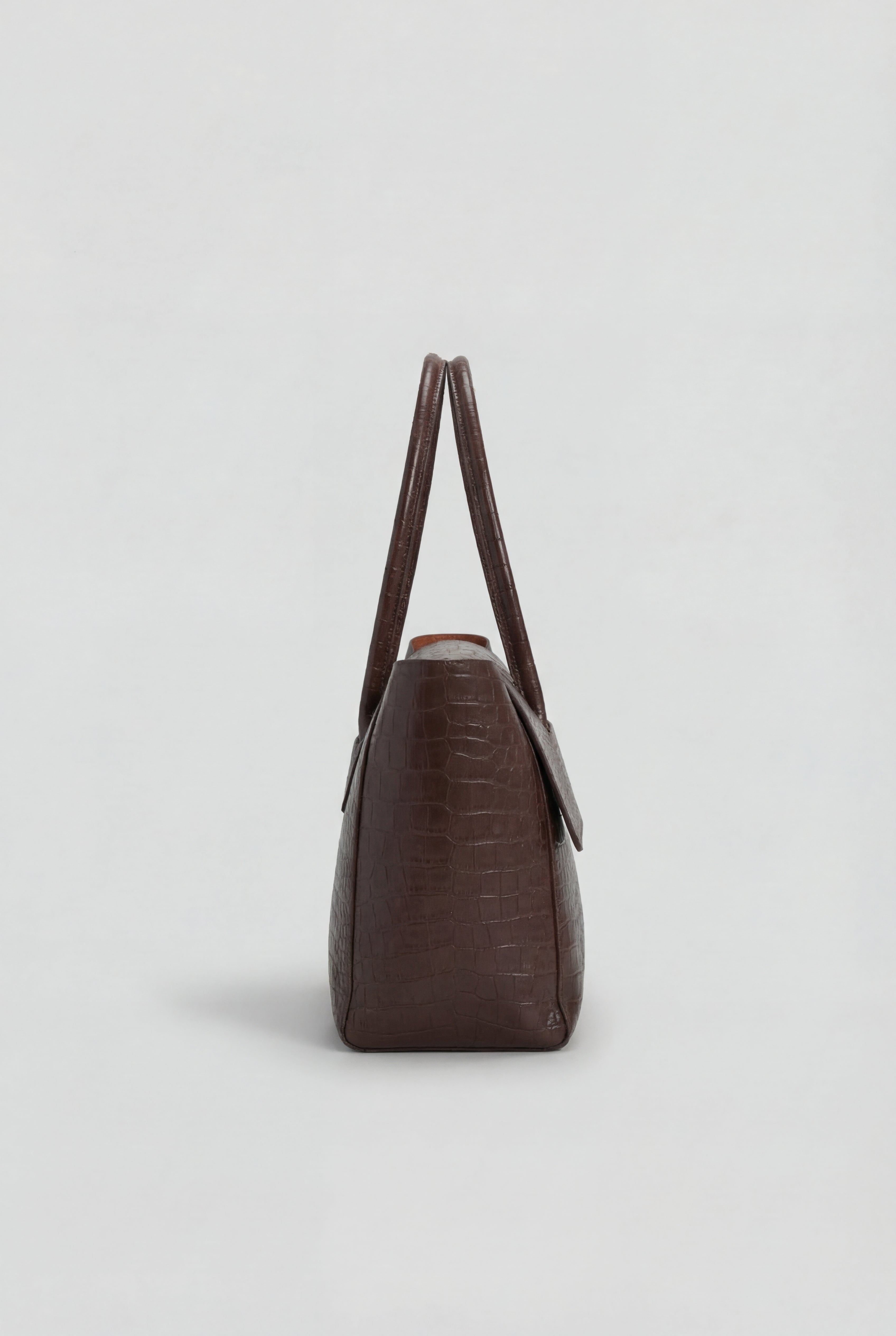 Elegant black crocodile leather handbag by Lumina Wear with adjustable strap, featuring sophisticated design and sleek finish.