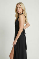 Elegant black halter neck dress by Lumina Wear, featuring a versatile fit and stylish design perfect for formal occasions.