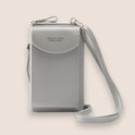 Elegant black leather clutch bag by Lumina Wear with versatile strap, featuring a sleek design and compact hand-held style.
