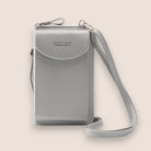 Elegant black leather clutch bag with versatile strap from Lumina Wear, featuring a sleek design and compact handheld style.