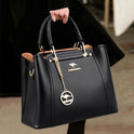Elegant black leather handbag with gold accents from Lumina Wear, featuring a structured design and stylish details.