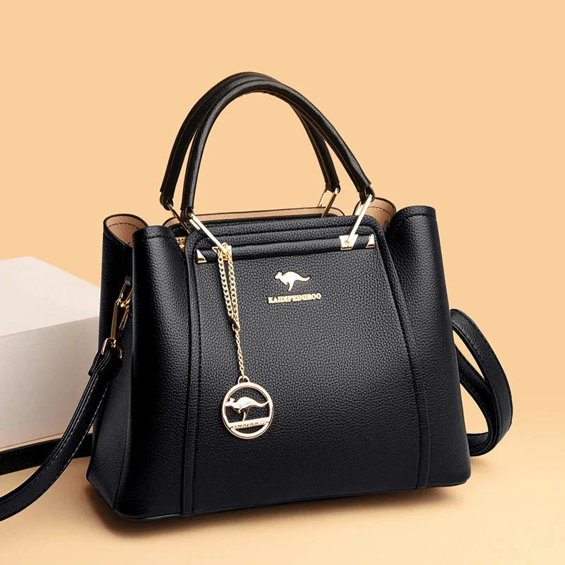 Elegant black leather handbag with gold accents from Lumina Wear, featuring a structured design and top handle.