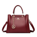 Elegant black leather handbag with gold accents from Lumina Wear, featuring a sleek design and top handle.