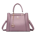 Elegant black leather handbag with gold accents from Lumina Wear, featuring a structured design and stylish handles.