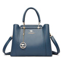 Elegant black leather Lumina Wear Isabella handbag with gold accents, featuring a sleek design and structured shape.