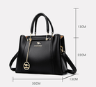 Elegant black leather handbag with gold accents from Lumina Wear's Isabella collection, featuring a sleek design and stylish details.