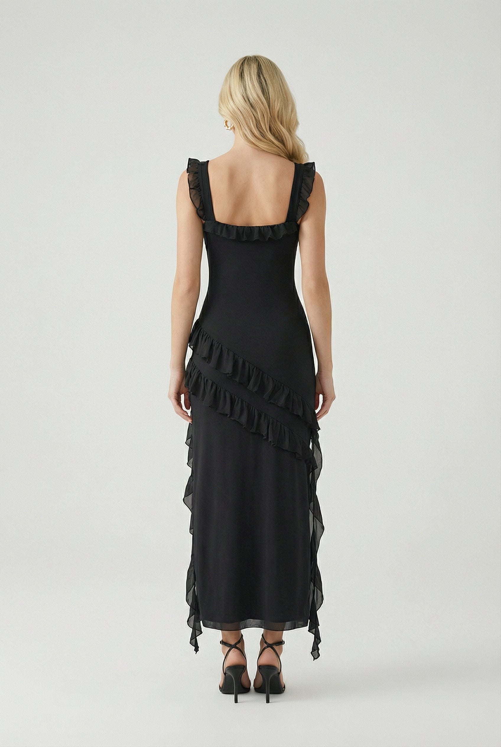 Elegant black maxi dress with high slit by Lumina Wear, featuring a flowing fabric and stylish design for women's evening wear.