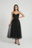 Elegant black midi dress with sleeveless design by Lumina Wear, featuring a fitted silhouette and stylish details.