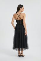 Elegant black sleeveless midi dress by Lumina Wear, featuring a fitted silhouette and stylish design, perfect for formal occasions.