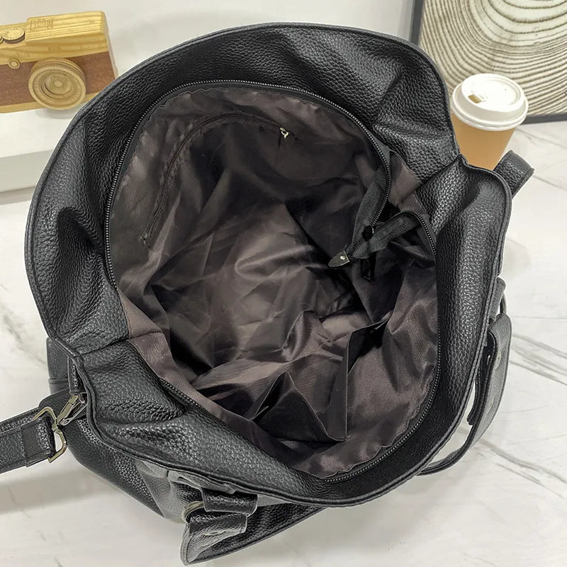 Elegant black synthetic leather tote bag from Lumina Wear, featuring a spacious design and sleek handles for stylish carrying.
