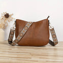 Elegant black vegan leather shoulder bag by Lumina Wear with adjustable strap, featuring a sleek design and top handle.