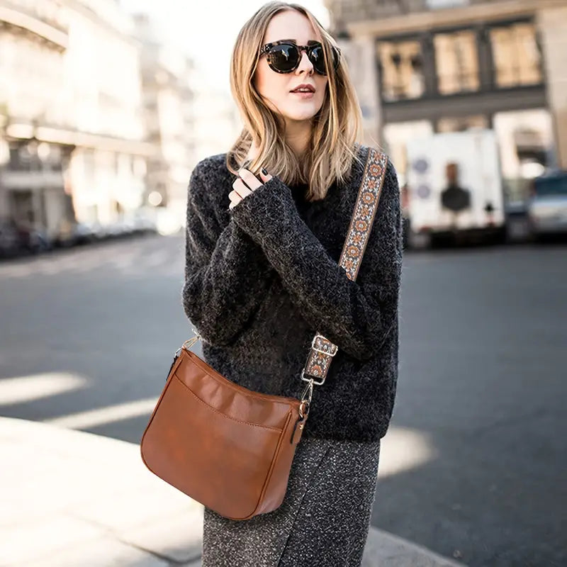 Black vegan leather shoulder bag with adjustable strap, elegant design from Lumina Wear's Isabella handbag collection.