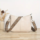 Elegant black vegan leather shoulder bag with adjustable strap from Lumina Wear, featuring a sleek design and spacious interior.