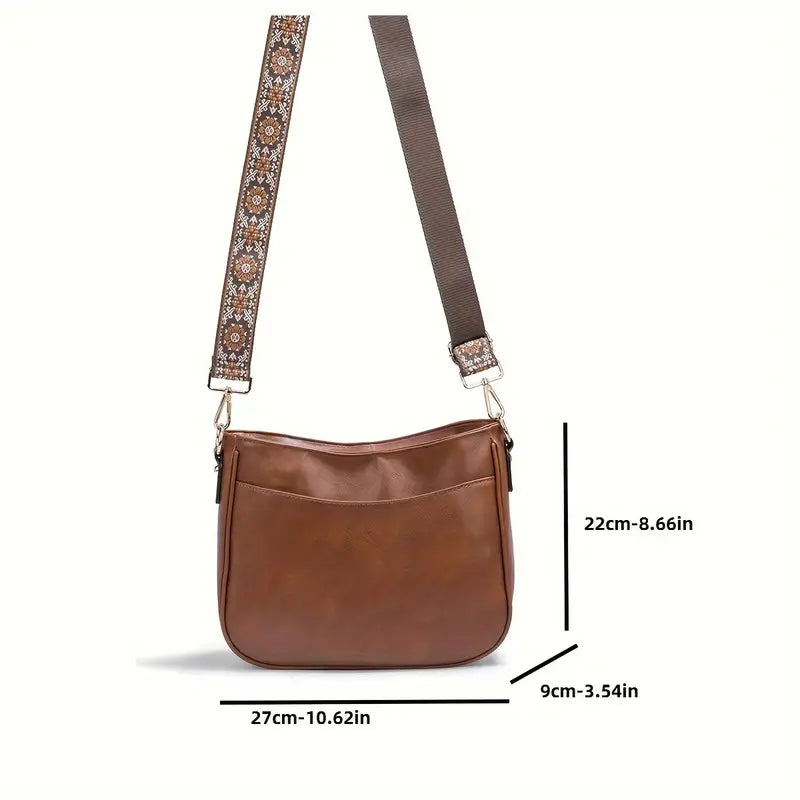 Elegant black vegan leather shoulder bag with adjustable strap from Lumina Wear, featuring a stylish design and spacious interior.