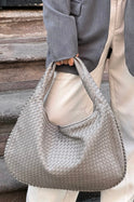 Elegant black vegan leather tote bag from Lumina Wear featuring a spacious design and sturdy handles.