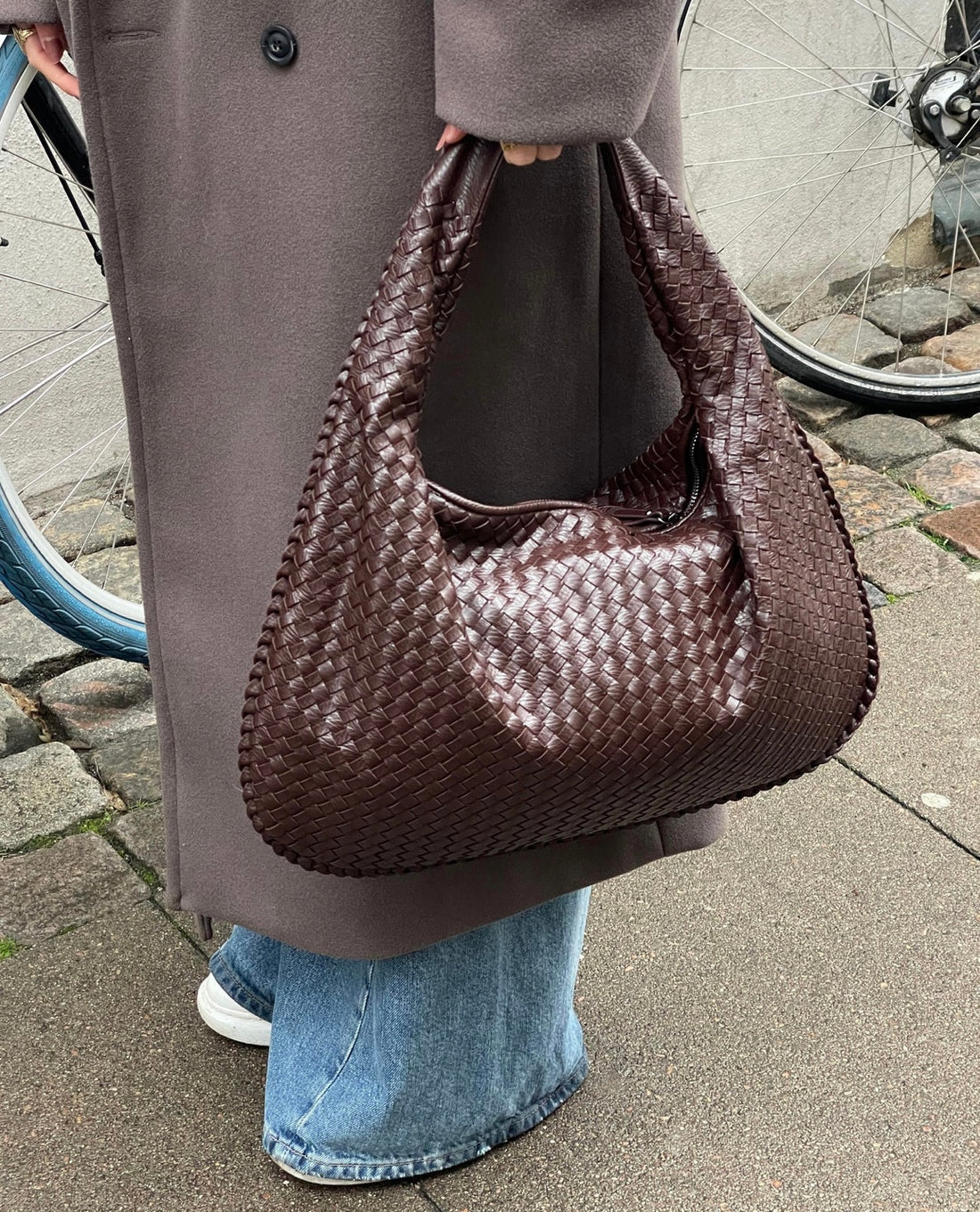 Elegant black vegan leather tote bag by Lumina Wear, featuring spacious interior and sturdy handles, perfect for everyday use.