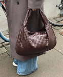 Elegant black vegan leather tote bag by Lumina Wear, featuring a spacious design and sturdy handles.