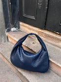 Elegant black vegan leather tote bag by Lumina Wear, showcasing spacious interior and sleek design, perfect for everyday use.