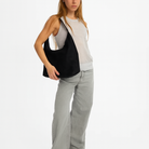 Elegant black vegan suede tote bag from Lumina Wear, featuring a spacious design and sleek handles for stylish everyday use.