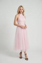Elegant blush midi dress from Lumina Wear featuring a flattering silhouette, perfect for sophisticated occasions.