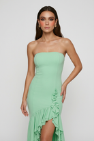 Elegant green flowing dress with asymmetrical ruffle by Lumina Wear, featuring a graceful, lightweight fabric and stylish design.